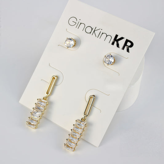 Minimal composition of GinaKimKR Lightfall Duo Earring Set, featuring sleek gold bar and stud drop designs.