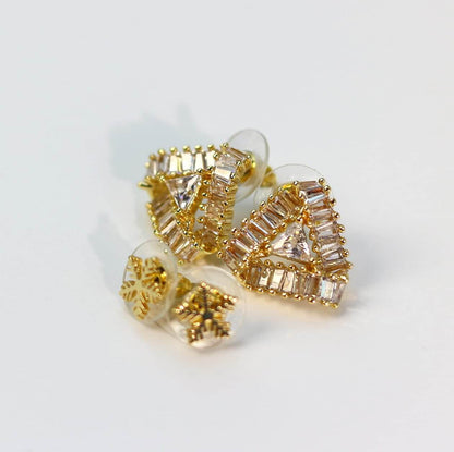 Side-angle image of clustered clear and golden CZ studs with snowflake-inspired sparkle effect.