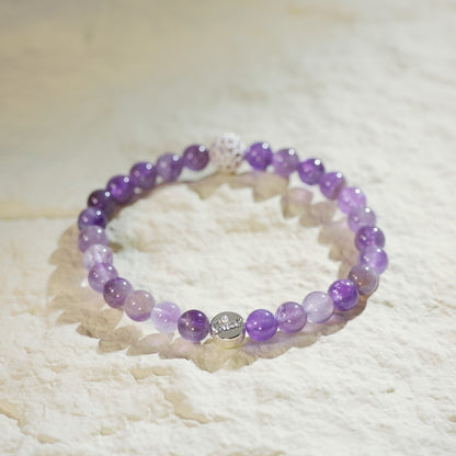 Stretch bracelet with deep violet amethyst, a sparkly CZ bead, and GinaKimKR charm. A refined, calming gemstone piece for everyday elegance.