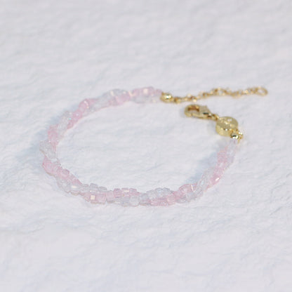Close-up of the Blush Prism Bracelet with delicate pink and clear CZ beads, finished with a gold clasp and extension chain on white background.