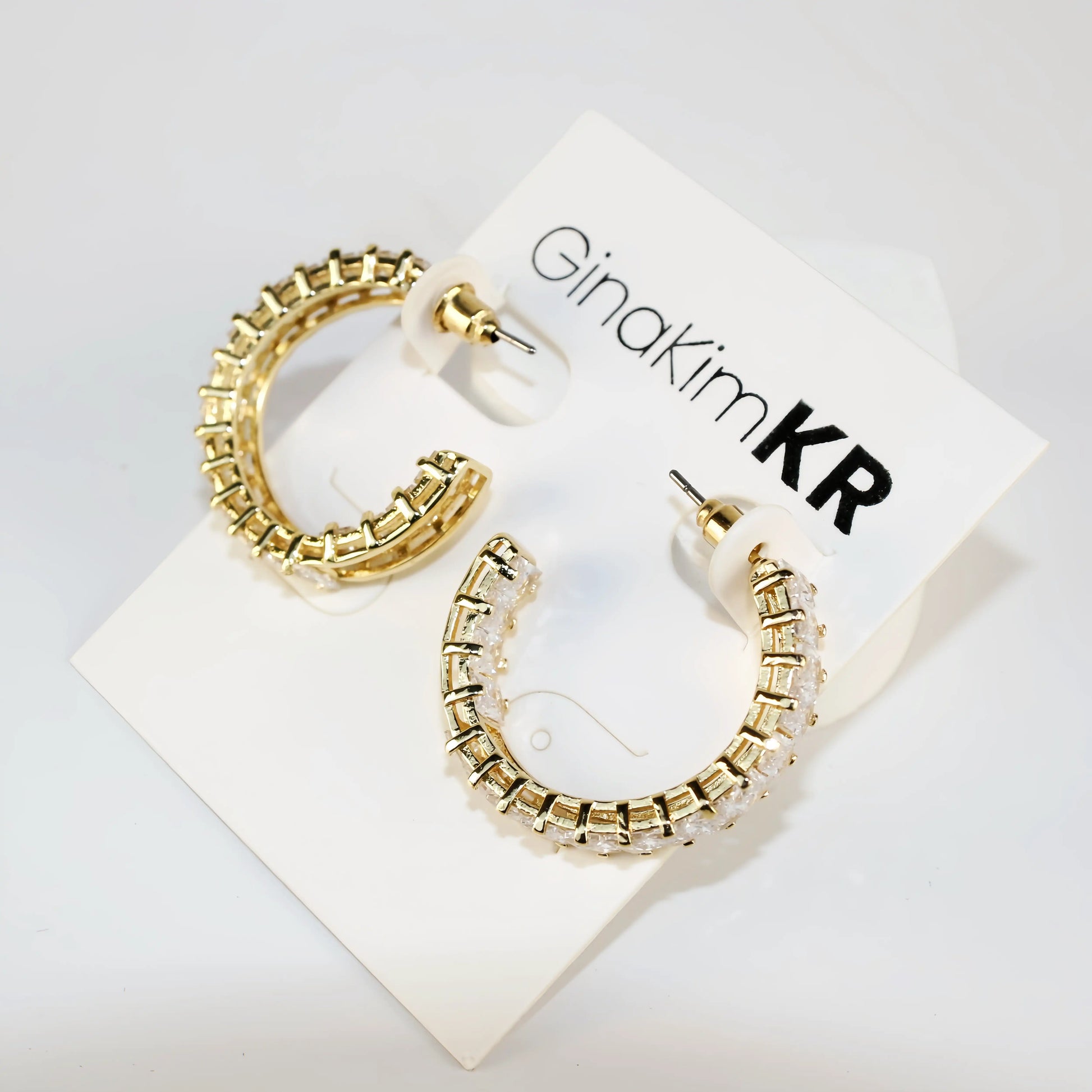 Celeste Crown Earrings shown at a side angle highlighting 28mm gold hoop thickness.