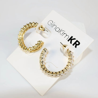 Celeste Crown Earrings shown at a side angle highlighting 28mm gold hoop thickness.
