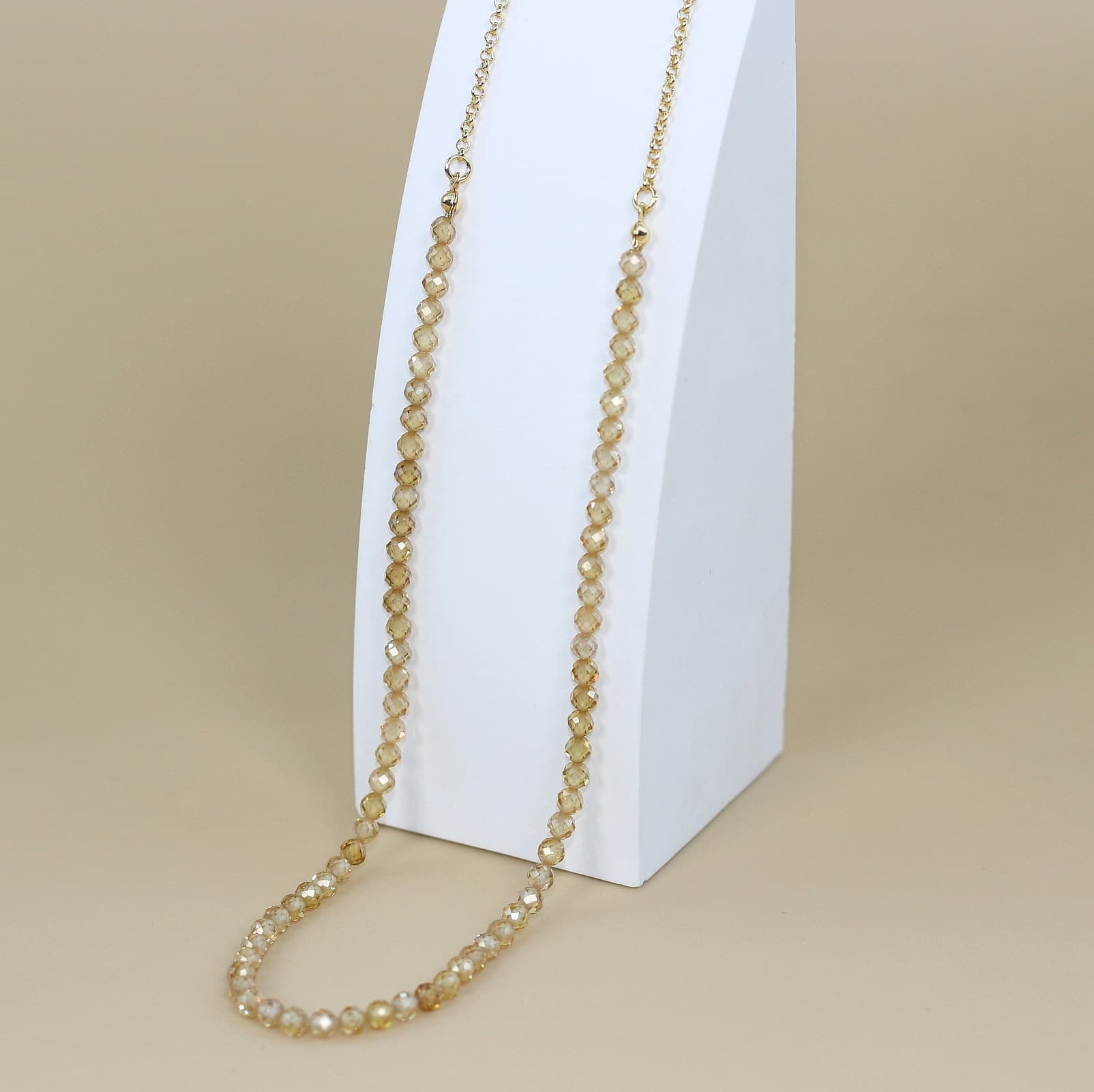 Champagne Light Necklace with faceted cubic zirconia beads and a gold-plated extender chain, styled for refined Korean elegance.
