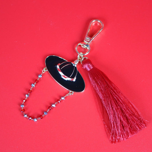 Crimson Stage Guardian Key Ring featuring a Korean-inspired black hat charm, deep red tassel, and delicate beaded chain on a red background, premium accessory by GinaKimKR.