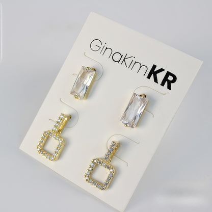 Bright-lit front shot of GinaKimKR earring set with gold pavé square drops and clear crystal-cut studs