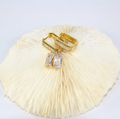 Top view of Crystal Line Duo earrings styled on soft white background – baguette hoops and CZ studs

