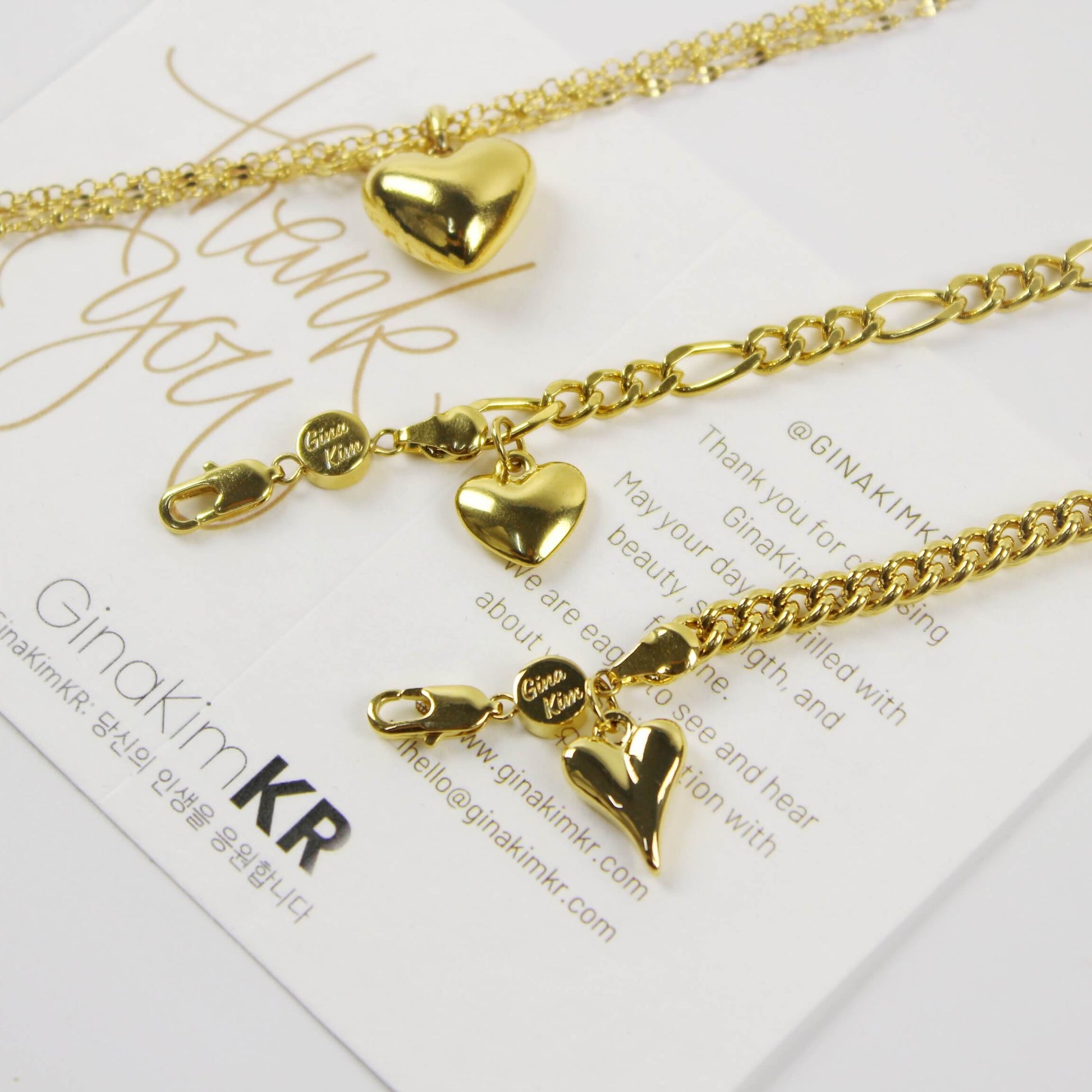 Evergold Figaro Heart Bracelet | GinaKimKR styled together with other Evergold Heart Bracelets on card display.