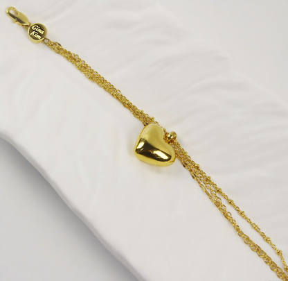 Side angle of Evergold Triple Chain Heart Bracelet showing layered gold chains