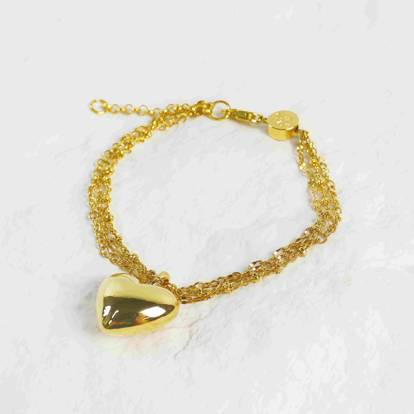 Top view of Evergold Triple Chain Heart Bracelet featuring heart charm centerpiece