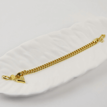 Flatlay of Evergold Twin-Link Heart Bracelet | by GinaKimKR with gold plating and lobster claw clasp.
