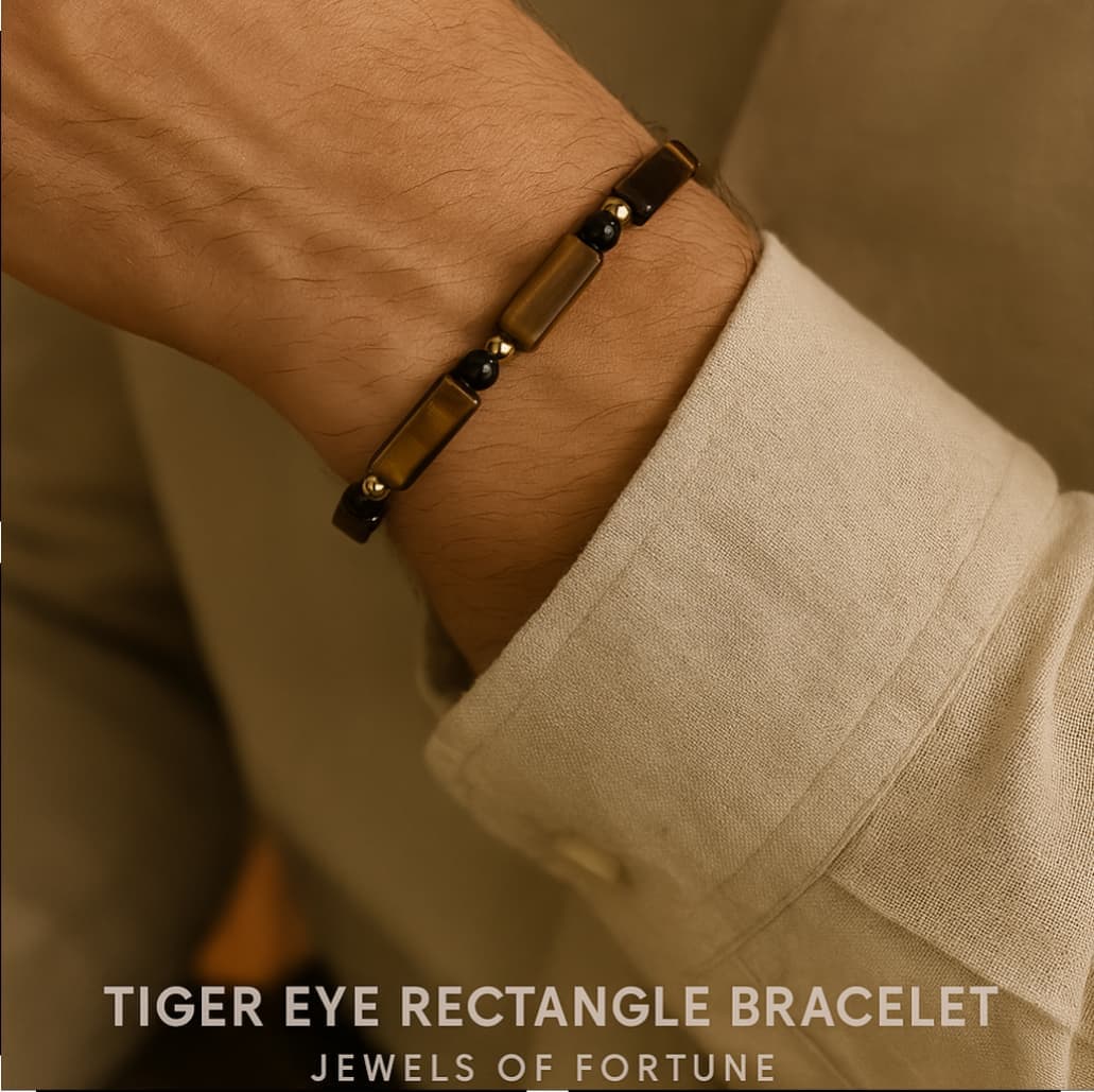 A Male model wearing the Focus Strength Bracelet by Gina Kim, with rich Tiger’s Eye and deep Onyx beads accented by gold. Powerful and refined.