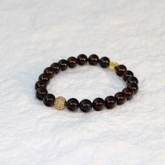 Front-facing image of the Garnet Strength Bracelet emphasizing its bold burgundy hue and natural elegance in a unisex design.