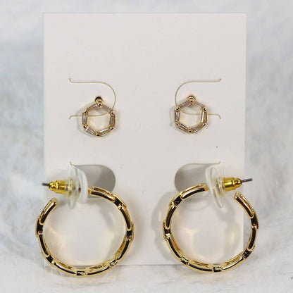 Front-facing card display of Geo Spark Earrings with octagon CZ studs and gold hoops with artistic cut-out detail and trapezoid accents.