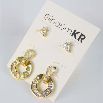 Golden Edge Duo by GinaKimKR – Elegant 2-pair earring set with triangle CZ studs and baguette crystal gold loop drops, shown on brand card