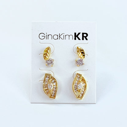 GinaKimKR's Harmony Leaf Trio Earring Set shown on display card, featuring gold leaf design with CZ stones.