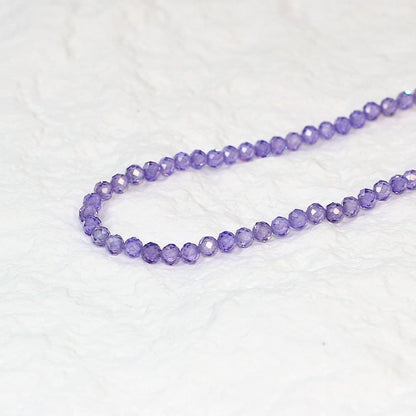 Detailed close-up of faceted lavender CZ beads from the Lavender Light Necklace, emphasizing clarity and cut.