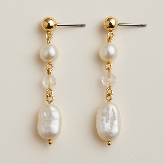 A pair of Lumière baroque pearl drop earrings featuring irregular freshwater pearls, faceted crystals, and 14K gold-plated accents. Elegant handmade design with stainless steel posts.
