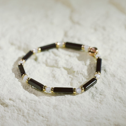 Midnight Focus Onyx Bracelet featuring sleek rectangular black onyx beads, clear crystal accents, and gold spacers. Korean-designed luxury stretch bracelet by GinaKim