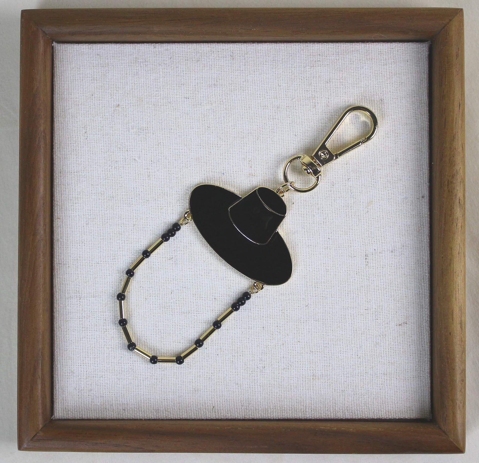 Midnight Shadow Hunter Key Ring styled in a wooden frame, Korean heritage hat design with K POP inspired JINU like energy.