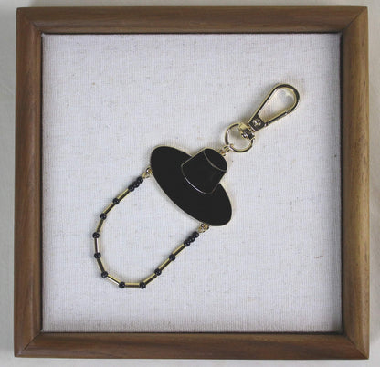 Midnight Shadow Hunter Key Ring styled in a wooden frame, Korean heritage hat design with K POP inspired JINU like energy.