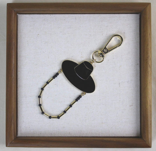 Midnight Shadow Hunter Key Ring styled in a wooden frame, Korean heritage hat design with K POP inspired JINU like energy.