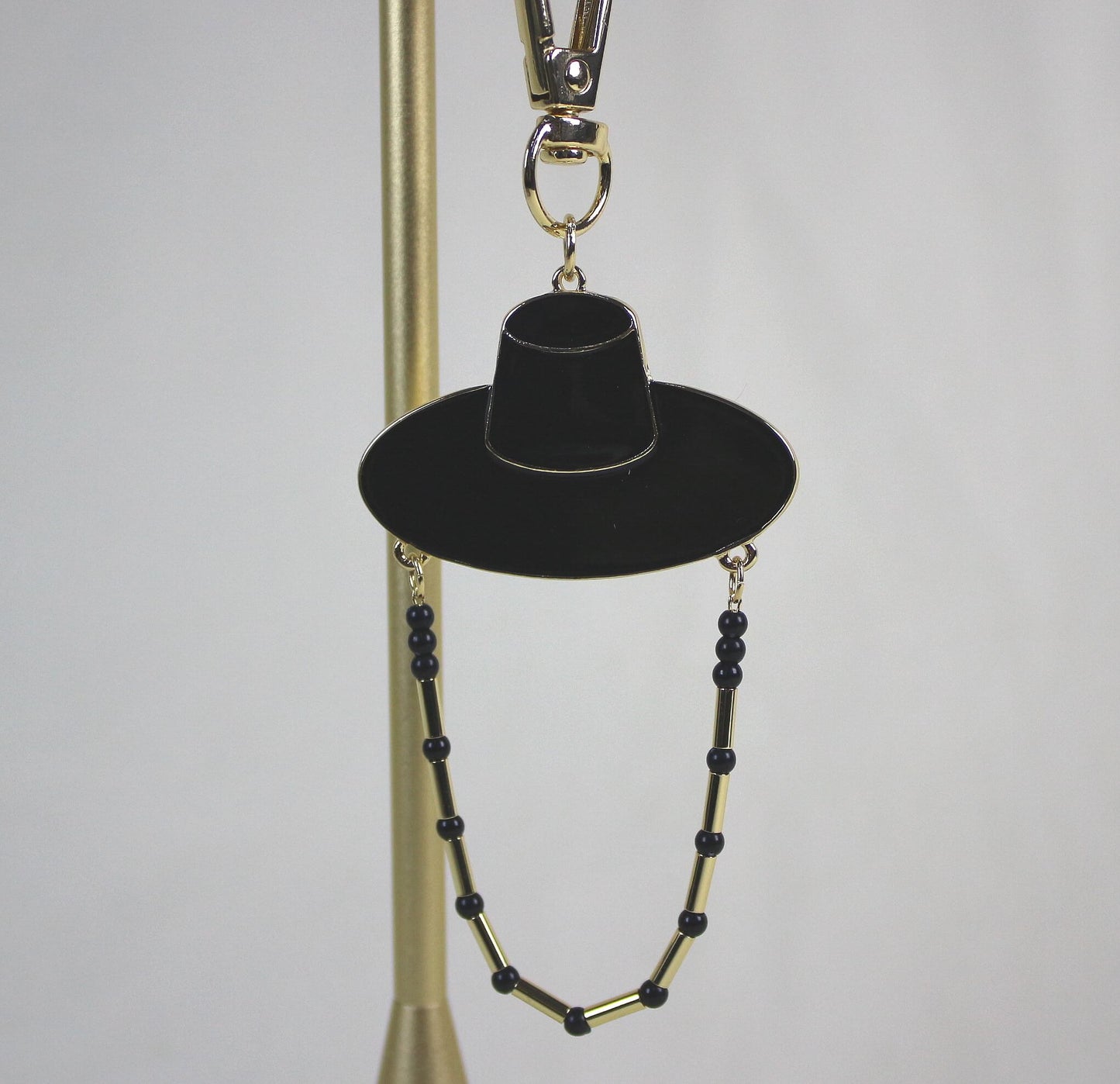 Close up of Midnight Shadow Hunter Key Ring featuring Korean traditional hat shape with subtle golden detail.