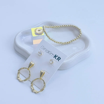 Coordinated jewelry flat lay featuring GinaKimKR Molten Circle Earring Set and gold bracelet