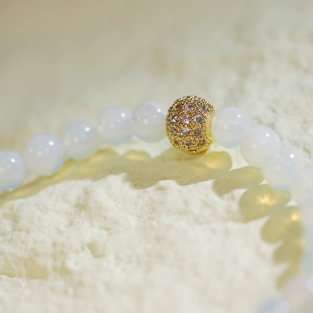 Close-up of the Moonstone Fortune Bracelet by GinaKimKR, featuring soft glow moonstone beads and a central gold CZ. Symbolizes intuition and balance.
