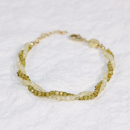 Flat-lay image of Olive Prism Bracelet highlighting the soft green CZ beads and subtle shimmer, arranged in a circular shape on a clean white background.