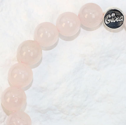 Close-up side shot of the Rose Quartz Strength Bracelet highlighting the smooth surface of the 8mm beads and subtle natural translucency.