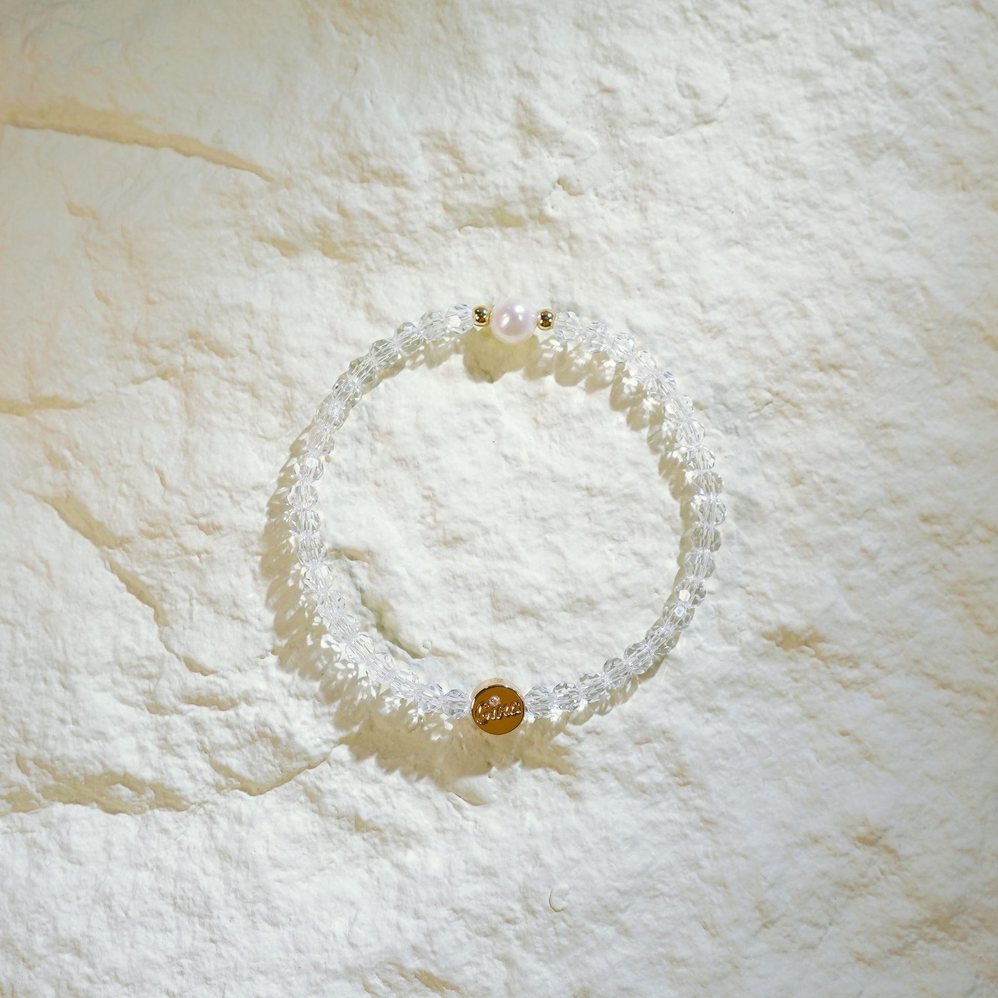 Handmade bracelet with faceted crystal quartz, one freshwater pearl, and gold-plated spacers. Designed by GinaKimKR for quiet elegance and inner clarity.