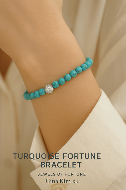 Close-up of a woman’s wrist wearing the Turquoise Fortune Bracelet by GinaKimKR. The soothing blue beads and gold accent radiate calm energy.