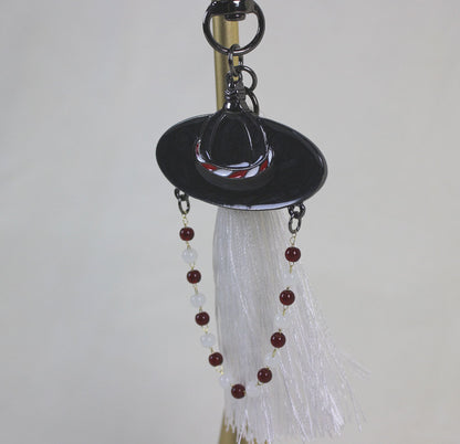 Full view of the White Spirit Hunter Key Ring showing Korean heritage inspired hat motif and RUMI like light filled mood.